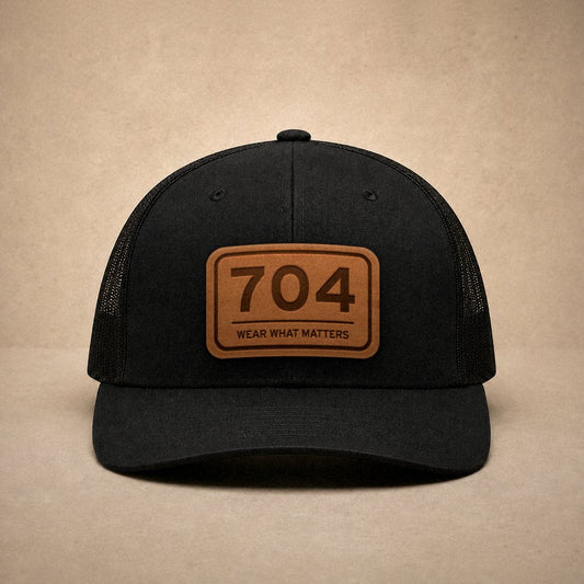 Black Charlotte hats — Charlotte 704 Leather Patch Trucker Hat