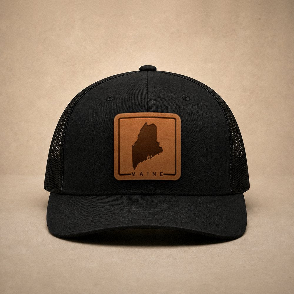 Black Maine hats — Maine Outline Leather Patch Trucker Hat