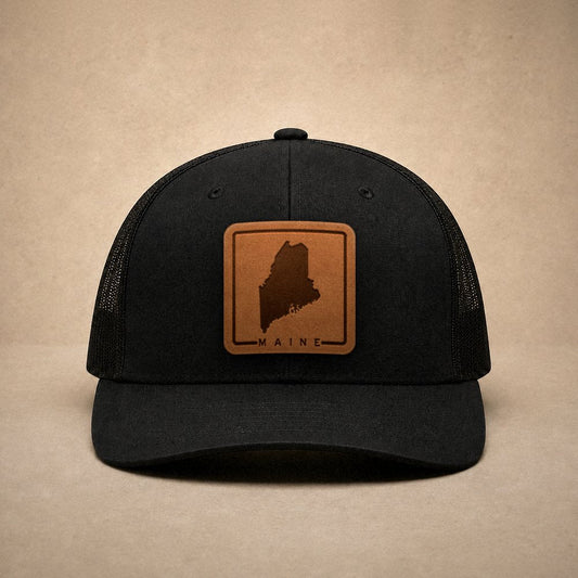 Black Maine hats — Maine Outline Leather Patch Trucker Hat