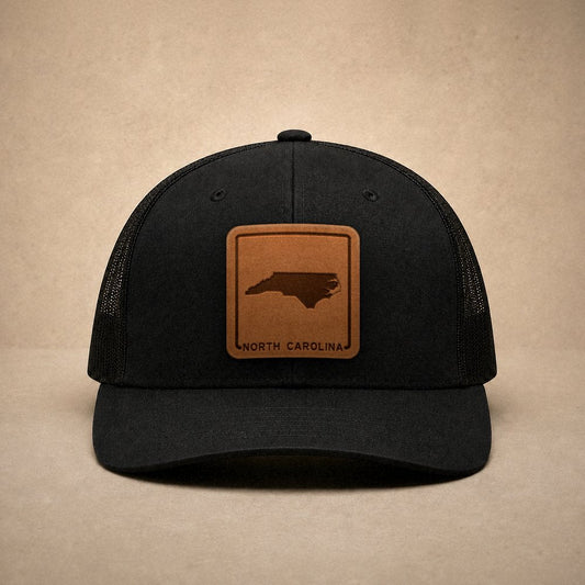 Black North Carolina hats — North Carolina Outline Leather Patch Trucker Hat