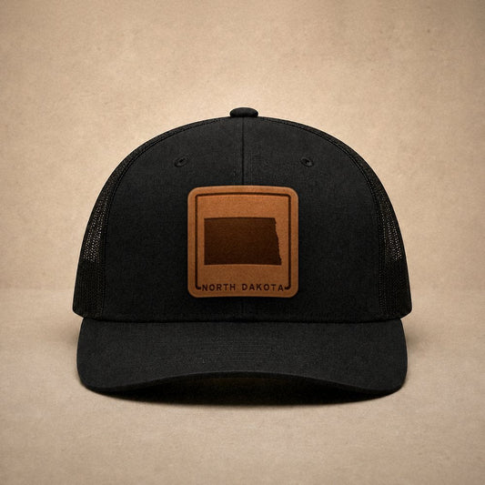 Black North Dakota hats — North Dakota Outline Leather Patch Trucker Hat
