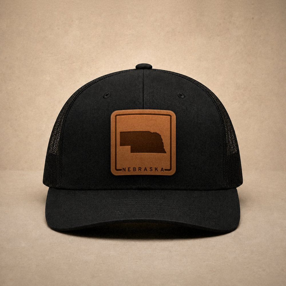 Black Nebraska hats — Nebraska Outline Leather Patch Trucker Hat
