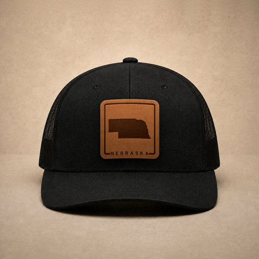 Black Nebraska hats — Nebraska Outline Leather Patch Trucker Hat