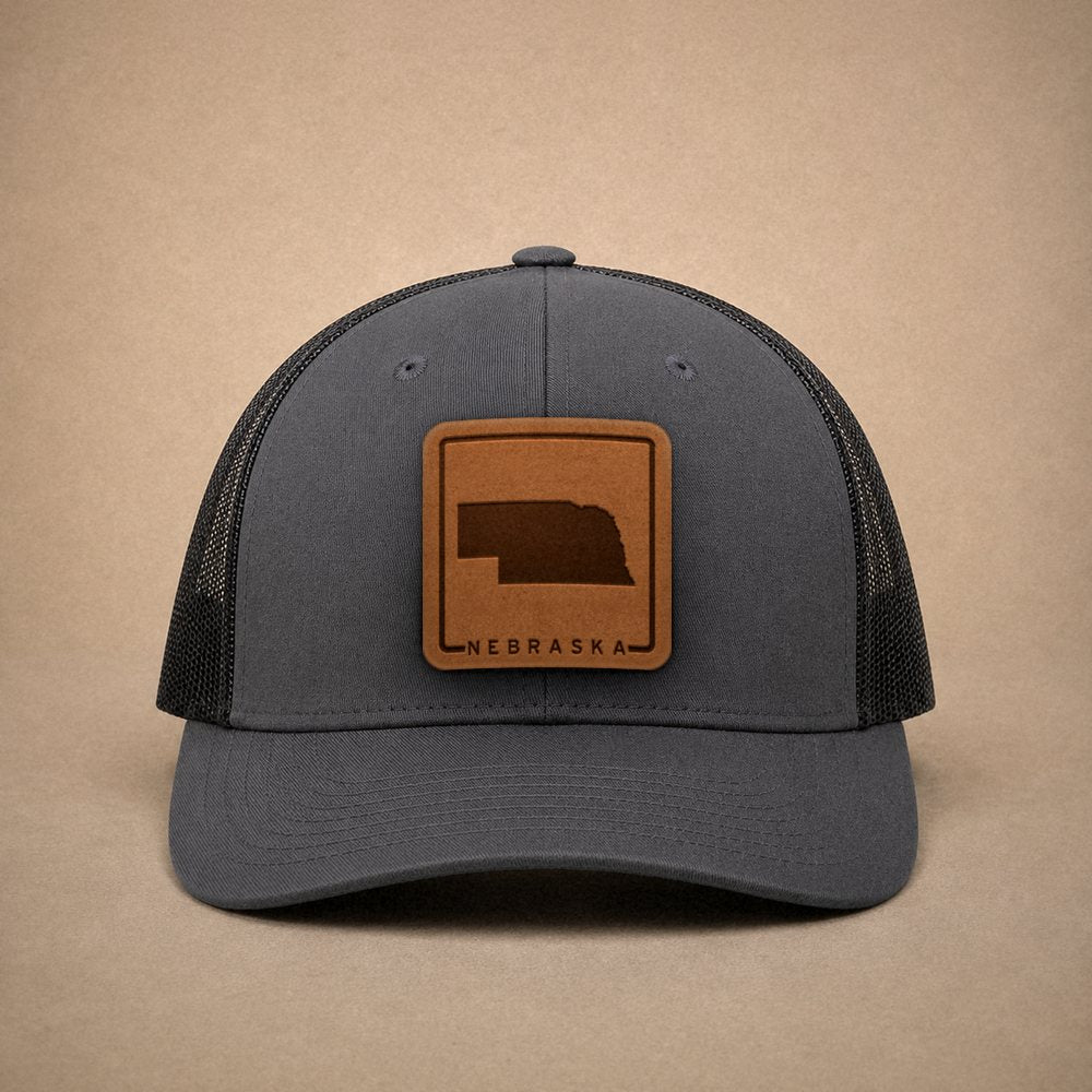 Charcoal Nebraska hats — Nebraska Outline Leather Patch Trucker Hat