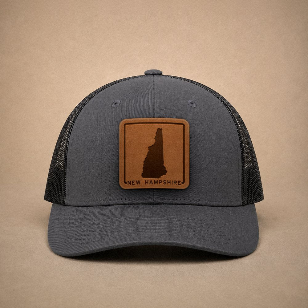 Charcoal New Hampshire hats — New Hampshire Outline Leather Patch Trucker Hat