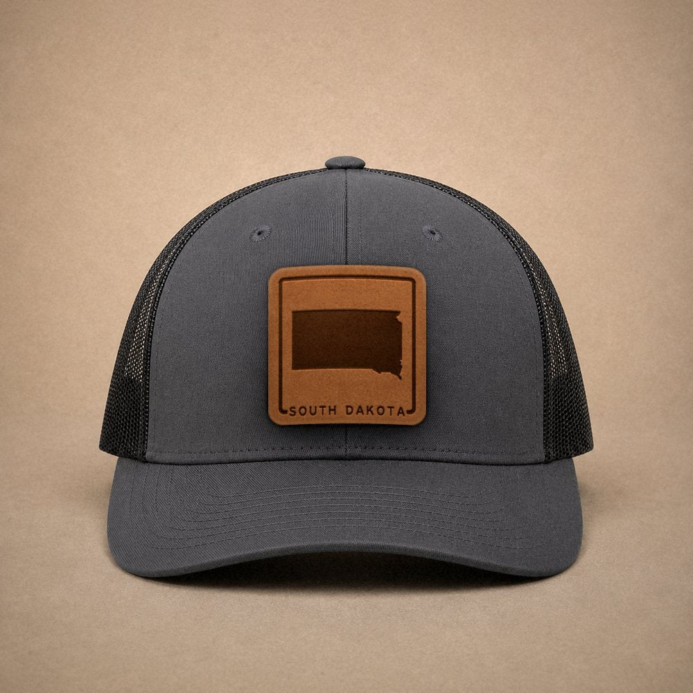 Charcoal South Dakota hats — South Dakota Outline Leather Patch Trucker Hat