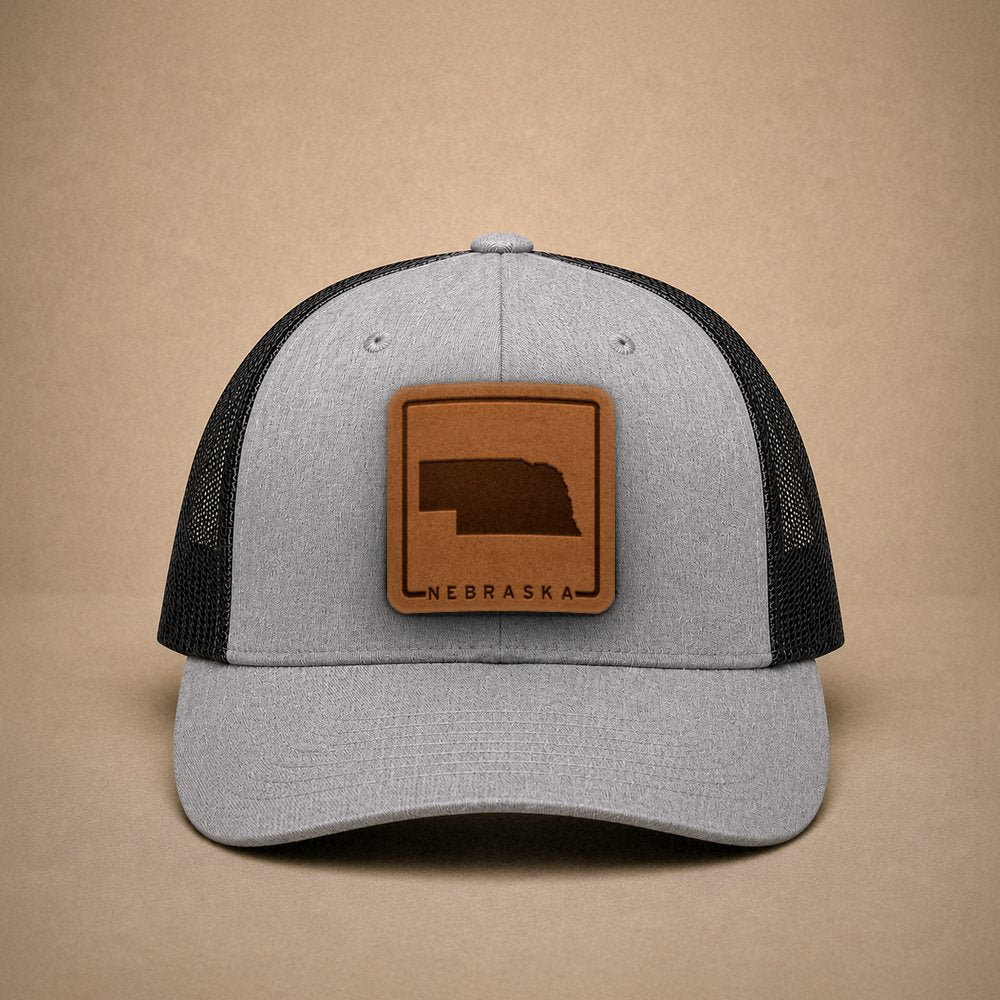 Heather Grey Nebraska hats — Nebraska Outline Leather Patch Trucker Hat