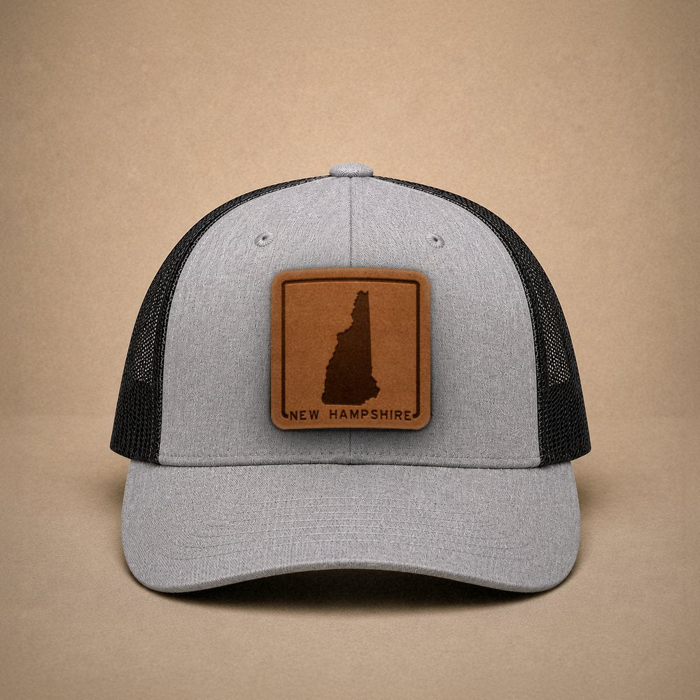Heather Grey New Hampshire hats — New Hampshire Outline Leather Patch Trucker Hat