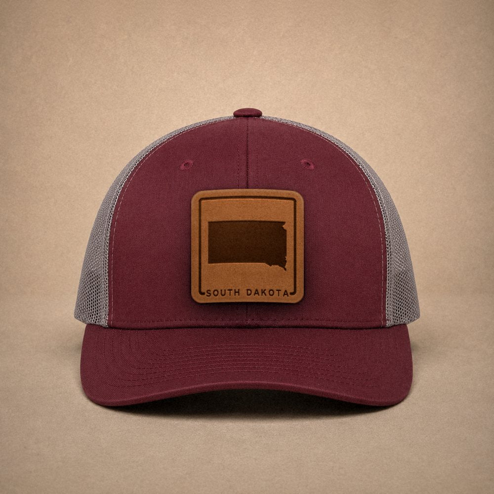 Maroon South Dakota hats — South Dakota Outline Leather Patch Trucker Hat