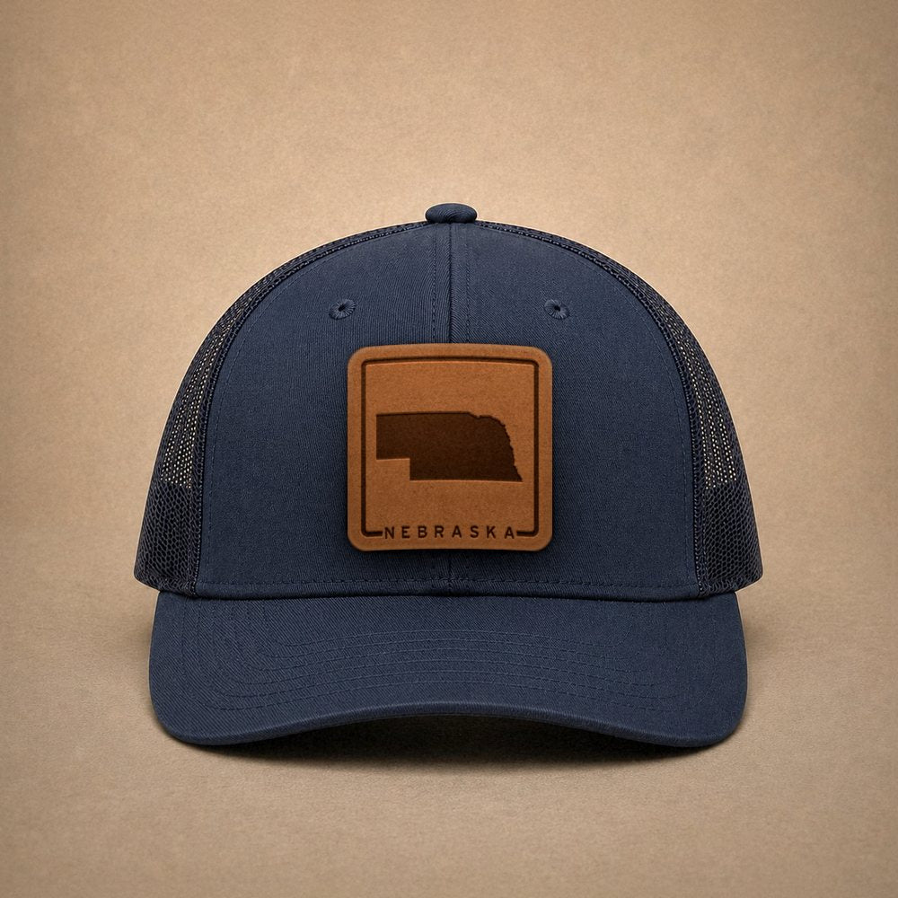 Navy Nebraska hats — Nebraska Outline Leather Patch Trucker Hat