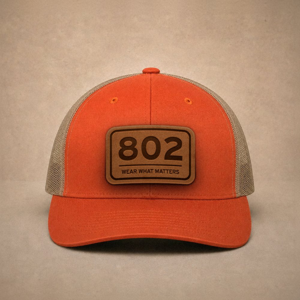 Orange Vermont hats — Vermont 802 Leather Patch Trucker Hat