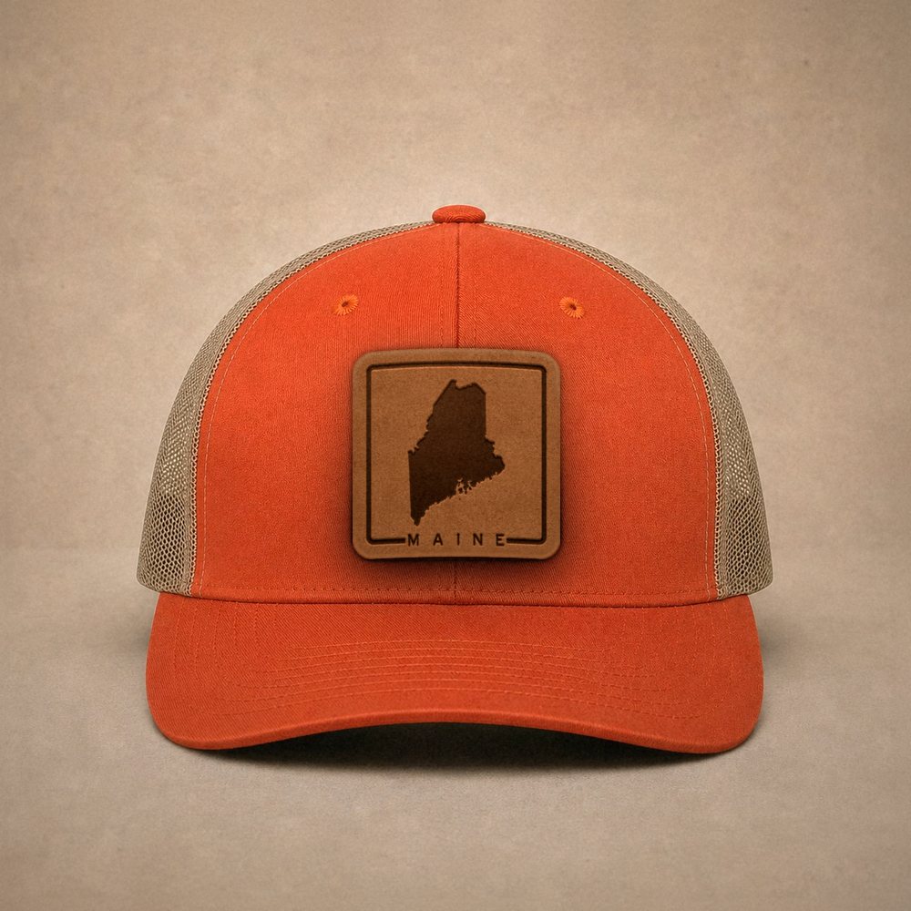 Orange Maine hats — Maine Outline Leather Patch Trucker Hat