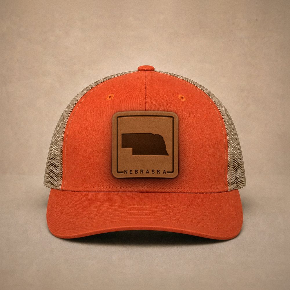 Orange Nebraska hats — Nebraska Outline Leather Patch Trucker Hat