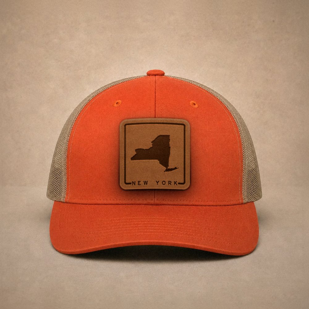Orange New York hats — New York Outline Leather Patch Trucker Hat