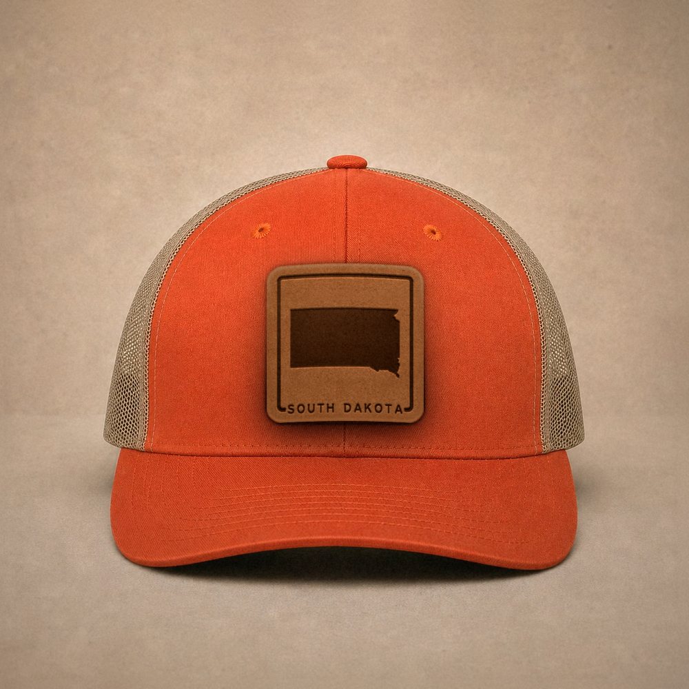 Orange South Dakota hats — South Dakota Outline Leather Patch Trucker Hat