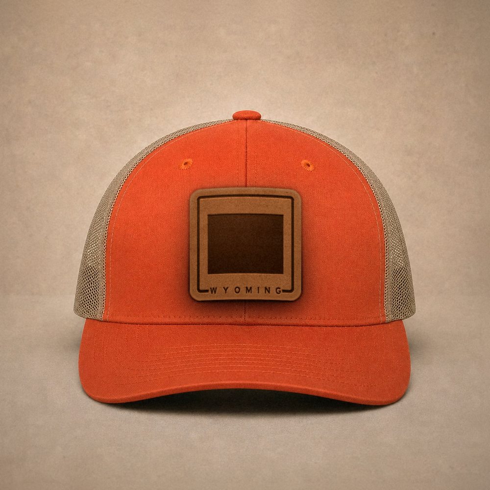 Orange Wyoming hats — Wyoming Outline Leather Patch Trucker Hat